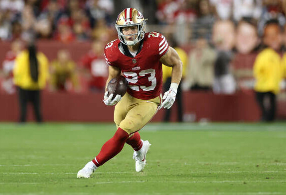 Christian McCaffrey running with the football